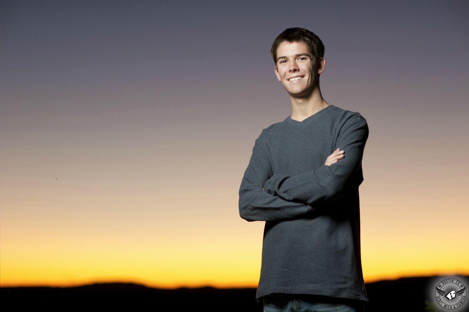 High school senior portraits Austin at the 360 Bridge overlook of smiling boy in sweater.